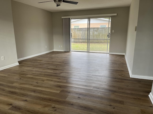 spare room featuring ceiling fan and dark wood-type flooring