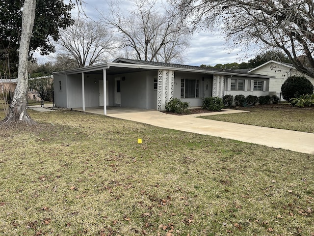 view of front facade with a front yard and a carport