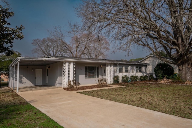 ranch-style house featuring a carport and a front yard