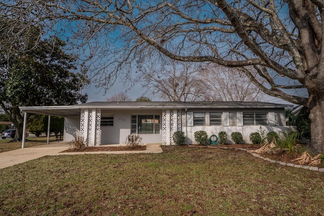 ranch-style house with a front lawn and a carport