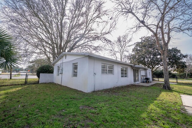 view of property exterior with a yard