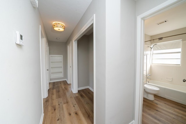 corridor with light wood-type flooring