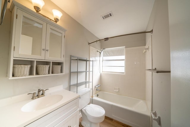 full bathroom with tiled shower / bath combo, vanity, and toilet