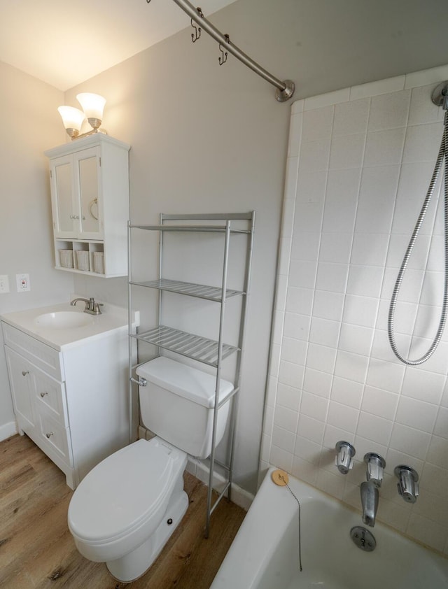 full bathroom featuring vanity, toilet, tiled shower / bath combo, and wood-type flooring