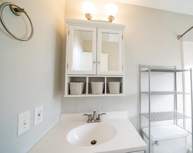 bathroom featuring vanity and toilet