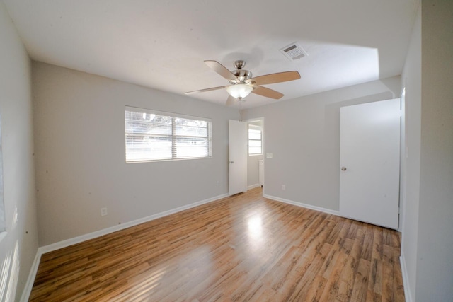 empty room featuring ceiling fan and light hardwood / wood-style floors