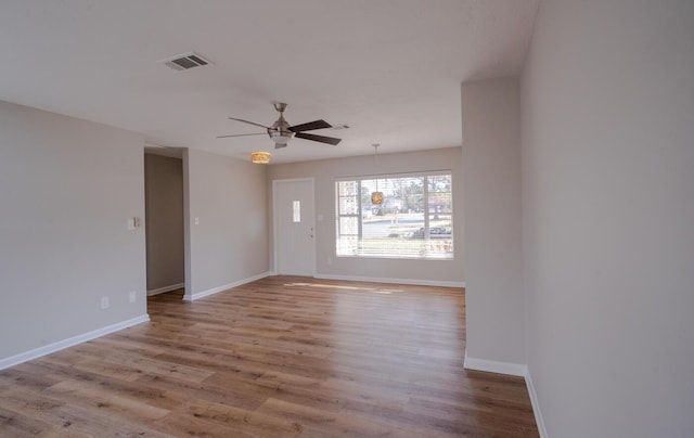 empty room featuring ceiling fan and light wood-type flooring