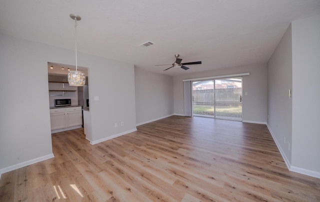 unfurnished living room featuring light hardwood / wood-style floors and ceiling fan