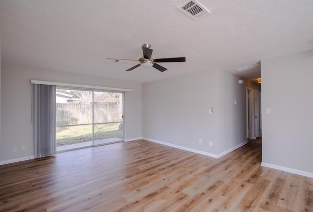 empty room with ceiling fan and light hardwood / wood-style floors