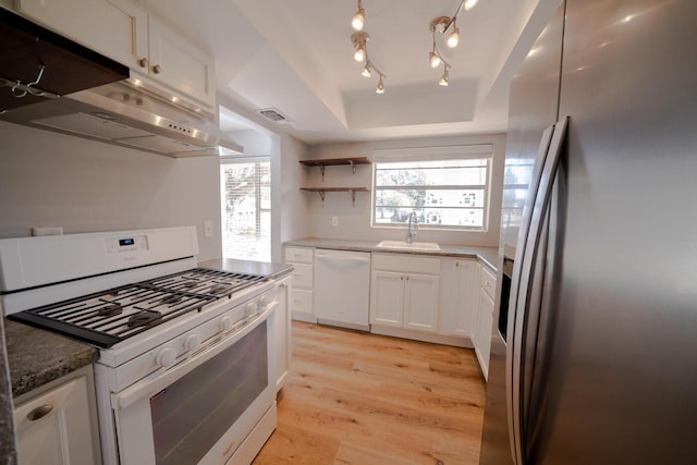 kitchen with sink, white appliances, white cabinetry, range hood, and light wood-type flooring