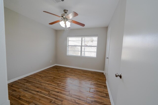 spare room with ceiling fan and dark hardwood / wood-style flooring