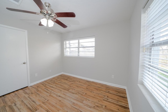 empty room with ceiling fan and light wood-type flooring