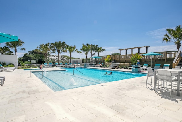 view of swimming pool featuring pool water feature, a patio, and a deck