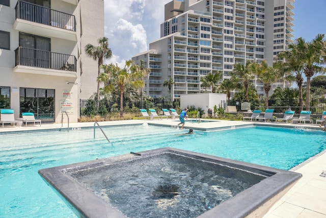 view of swimming pool with a community hot tub