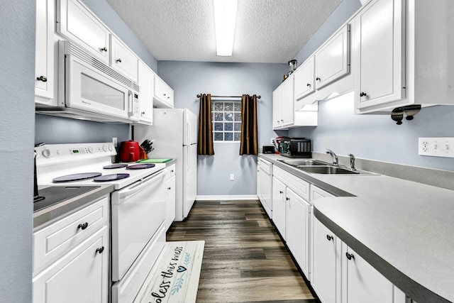 kitchen with white appliances, a textured ceiling, dark wood-type flooring, white cabinetry, and sink