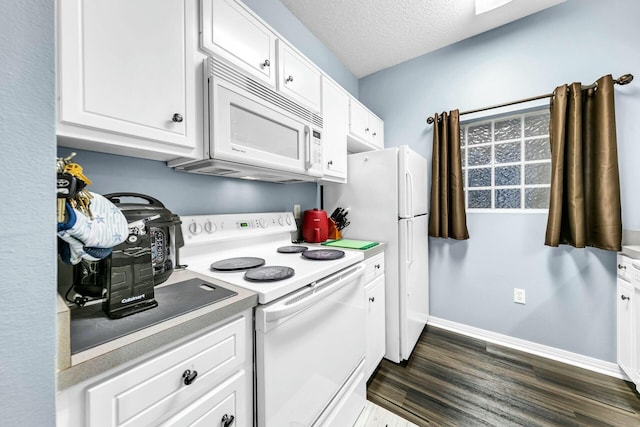 kitchen with dark hardwood / wood-style flooring, white appliances, white cabinetry, and a textured ceiling