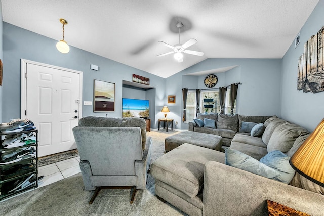 living room with a textured ceiling, ceiling fan, light tile patterned floors, and lofted ceiling