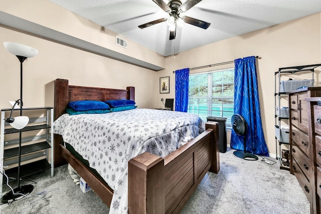 bedroom with a textured ceiling, ceiling fan, and carpet flooring