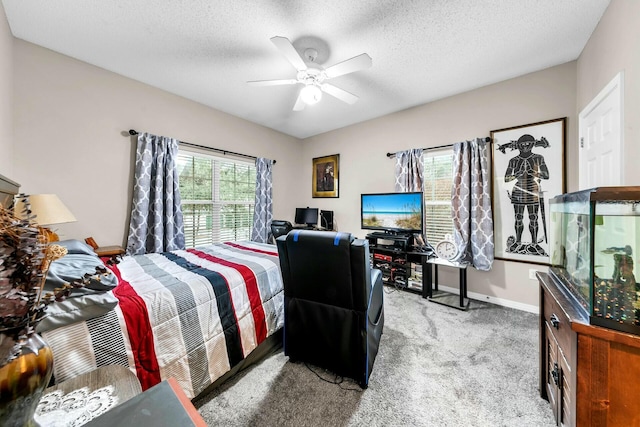 bedroom with ceiling fan, a textured ceiling, and light carpet