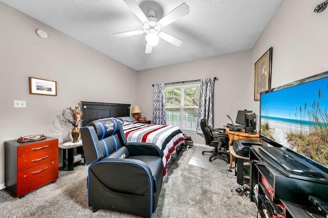 carpeted bedroom with ceiling fan and a textured ceiling