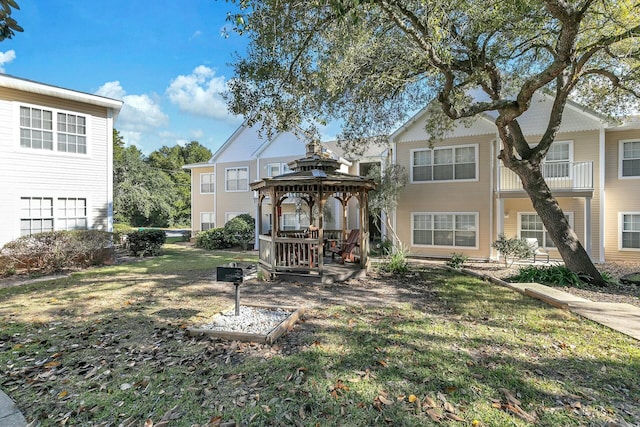 view of front of house featuring a gazebo and a front yard