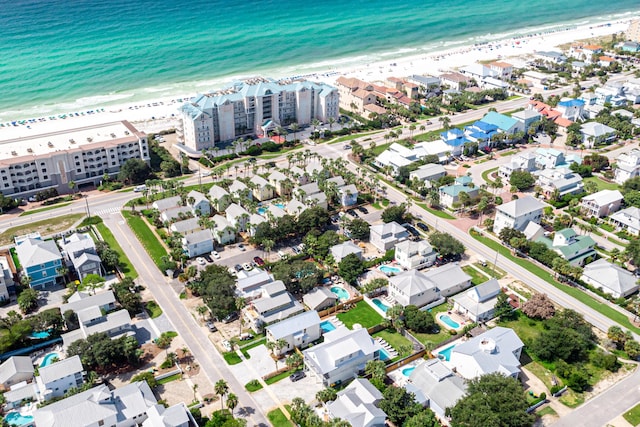 bird's eye view with a water view and a beach view