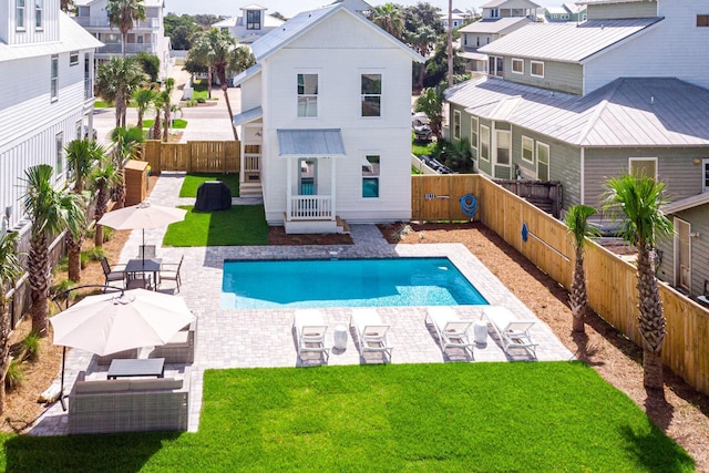 view of pool featuring a patio area and a yard