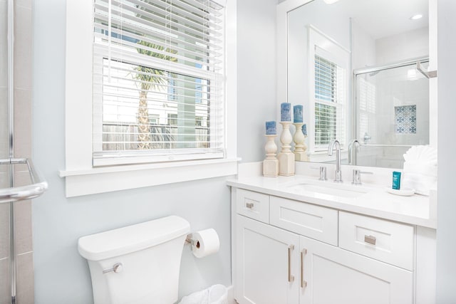 bathroom with vanity, toilet, and an enclosed shower