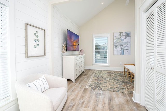 sitting room featuring light hardwood / wood-style flooring and high vaulted ceiling