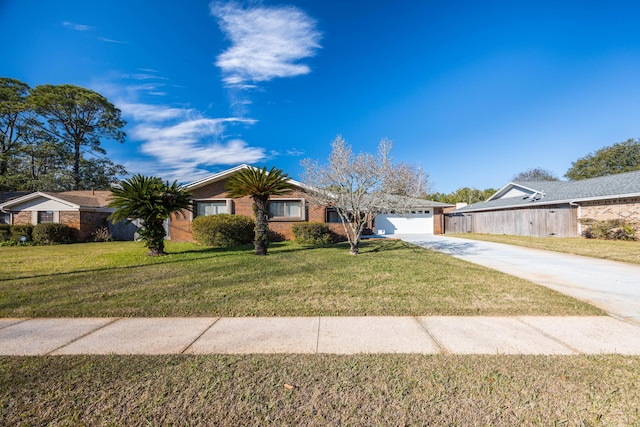 ranch-style house with a garage and a front lawn