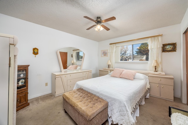 carpeted bedroom featuring a textured ceiling and ceiling fan