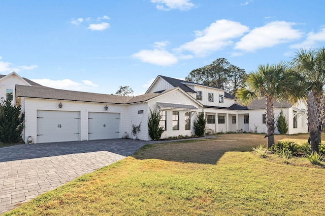 view of front of home featuring a garage and a front lawn