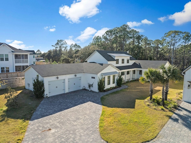 view of front of home featuring a garage and a front lawn