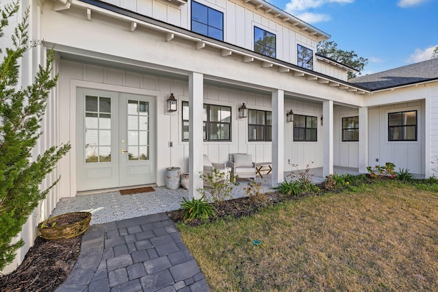 property entrance with french doors and a lawn