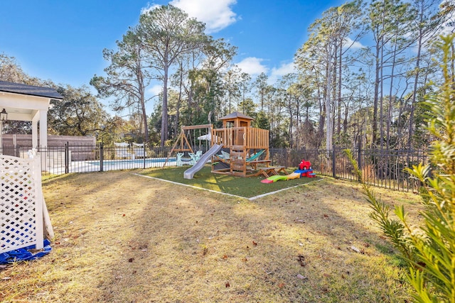 view of yard with a playground and a swimming pool