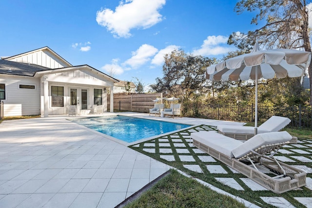 view of swimming pool featuring a patio area and french doors