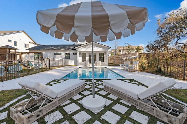 view of pool with a playground