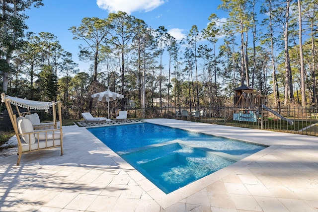 view of pool with a playground, an in ground hot tub, and a patio