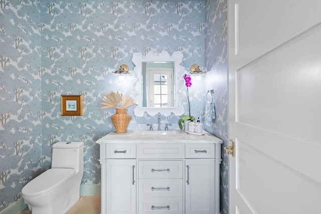 bathroom featuring vanity and toilet