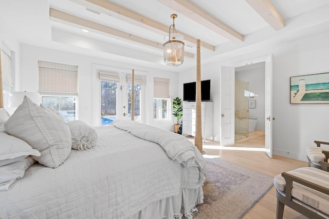 bedroom with light hardwood / wood-style floors, access to exterior, and ensuite bath