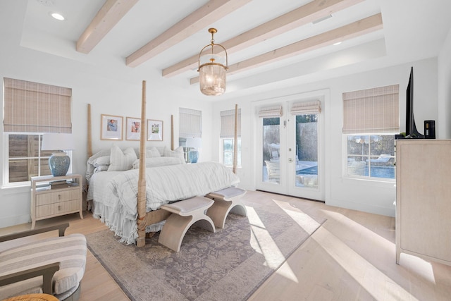 bedroom with an inviting chandelier, access to exterior, light wood-type flooring, and french doors