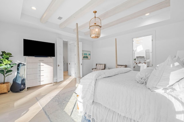 bedroom featuring beam ceiling and a raised ceiling