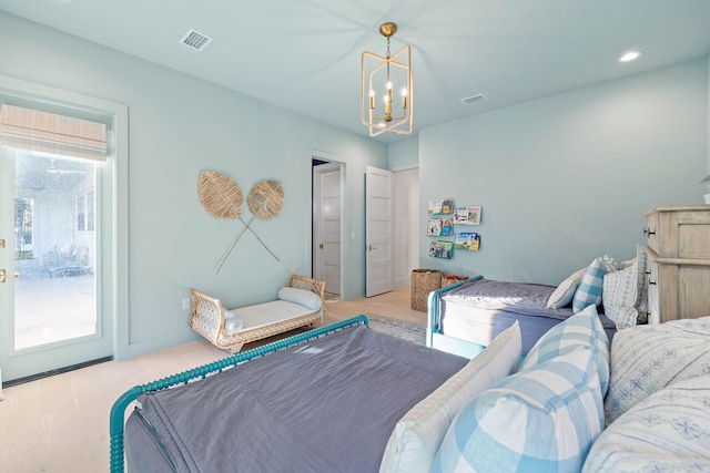 bedroom featuring light wood-type flooring and a notable chandelier