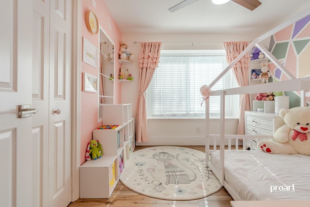 bedroom with ceiling fan and wood-type flooring