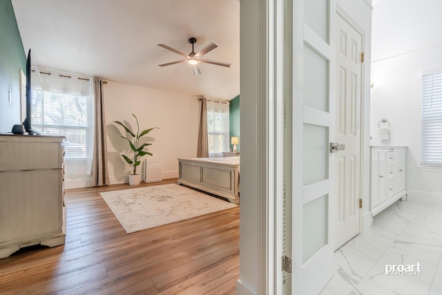 bedroom featuring multiple windows and light hardwood / wood-style flooring