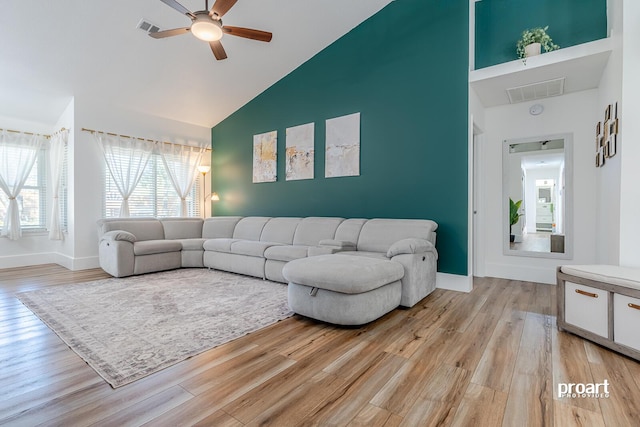 living room featuring light wood-type flooring, high vaulted ceiling, and ceiling fan