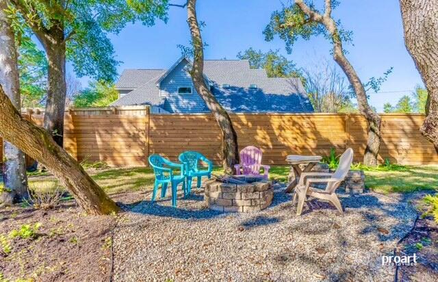 view of yard featuring an outdoor fire pit