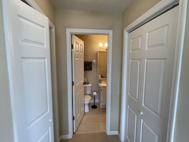 hallway featuring a textured ceiling