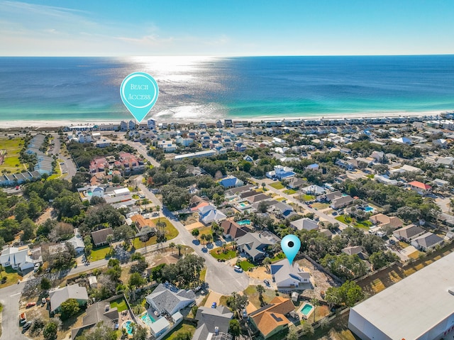 bird's eye view featuring a water view and a beach view