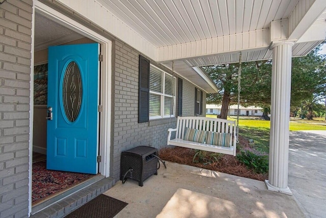 view of exterior entry with covered porch